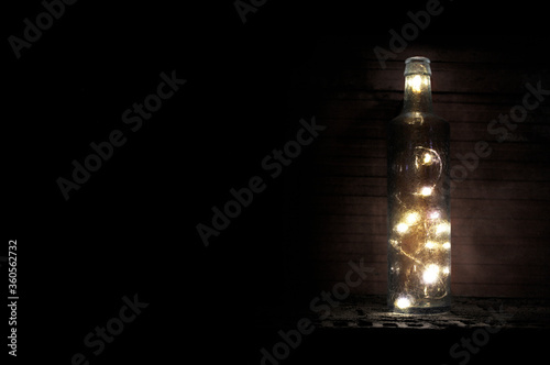 Bottle with lights on black background © RATOCA