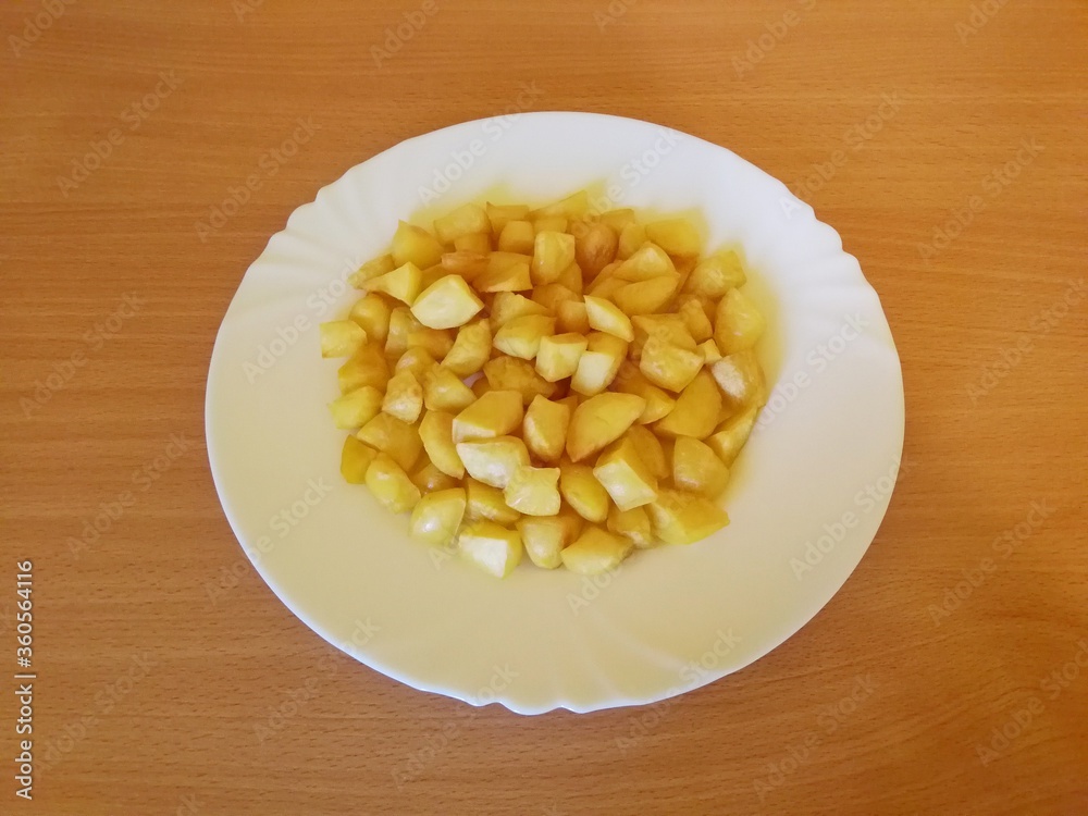 Roasted potatoes placed on a white porcelain plate Roasted potatoes placed on a white porcelain plate