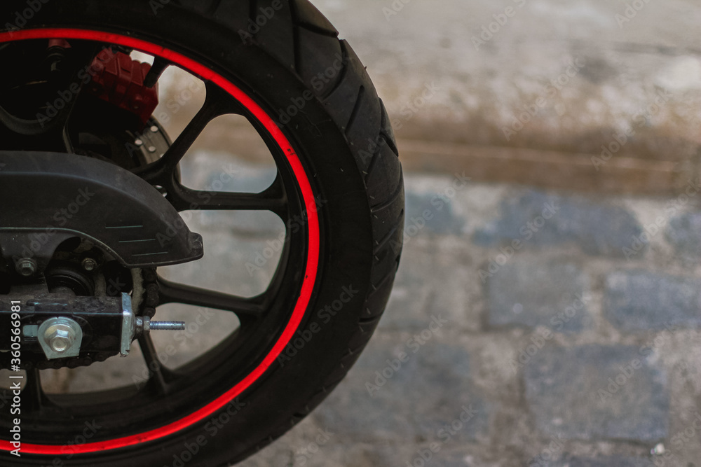 Black and red bike. Motorbike in city.