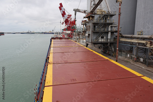 Top view of small general cargo ship berthed at sea port photo