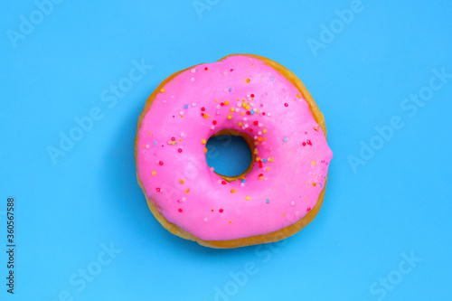 Pink donut on blue background.
