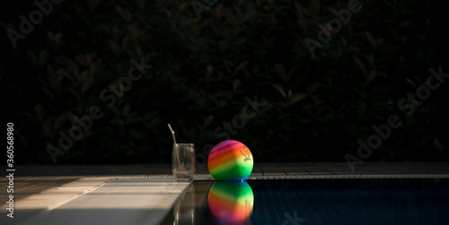 colorful ball and coffee mug by the pool