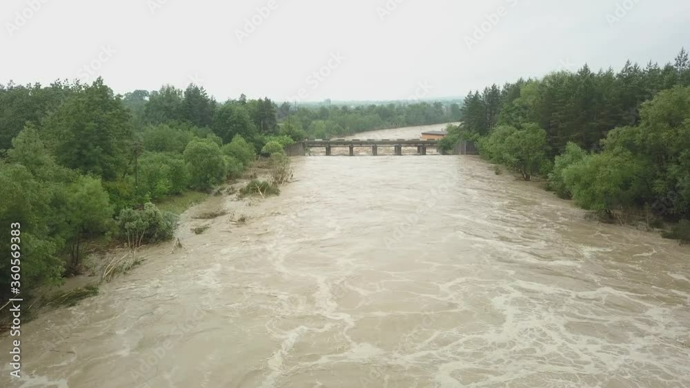 Aerial view of the bridge during floods. Extremely high water level in the river. Natural disaster in western Ukraine. Aerial view of the bridge during floods. Extremely high water level in the river. Natural disaster in western Ukraine.