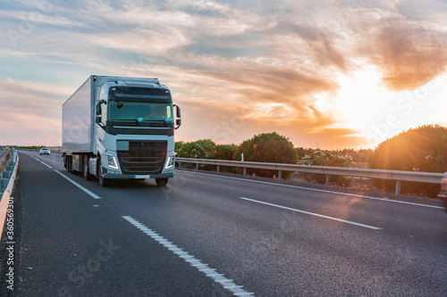 Truck with refrigerated semi-trailer moving on the highway