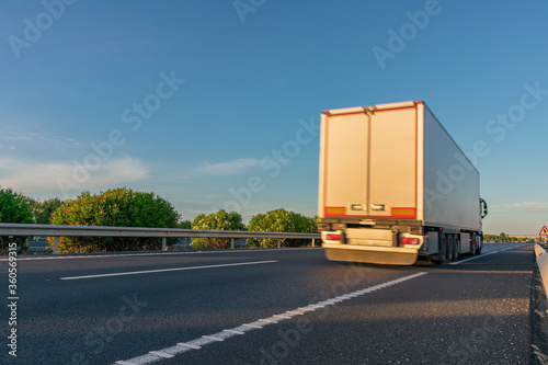 Truck with refrigerated semi-trailer moving on the highway
