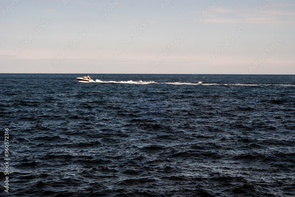 Speed Motor Boat Gliding Sea Waves under Blue Sky near Cap Ferrat Cape in Nice City, France - Leaving Frame Position Speed Motor Boat Gliding Sea Waves under Blue Sky near Cap Ferrat Cape in Nice City, France - Leaving Frame Position