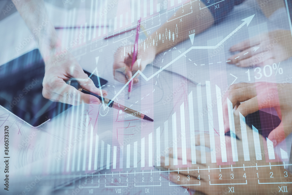 Double exposure of forex graph drawing and man and woman working together holding and using a mobile device. Trade concept. Double exposure of forex graph drawing and man and woman working together holding and using a mobile device. Trade concept.