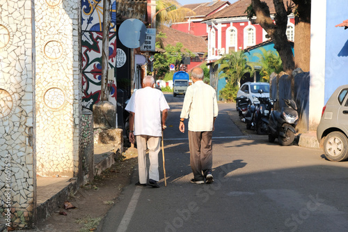 Two old men walking down the street in Portuguese area