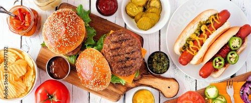 Фотография Summer BBQ food table scene with hot dog and hamburger buffet