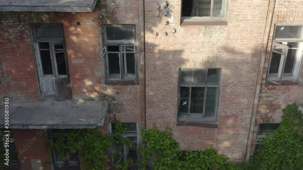 Abandoned early 20th century apartment house (multi-story building) with broken windows and balconies. Aerial view Abandoned early 20th century apartment house (multi-story building) with broken windows and balconies. Aerial view