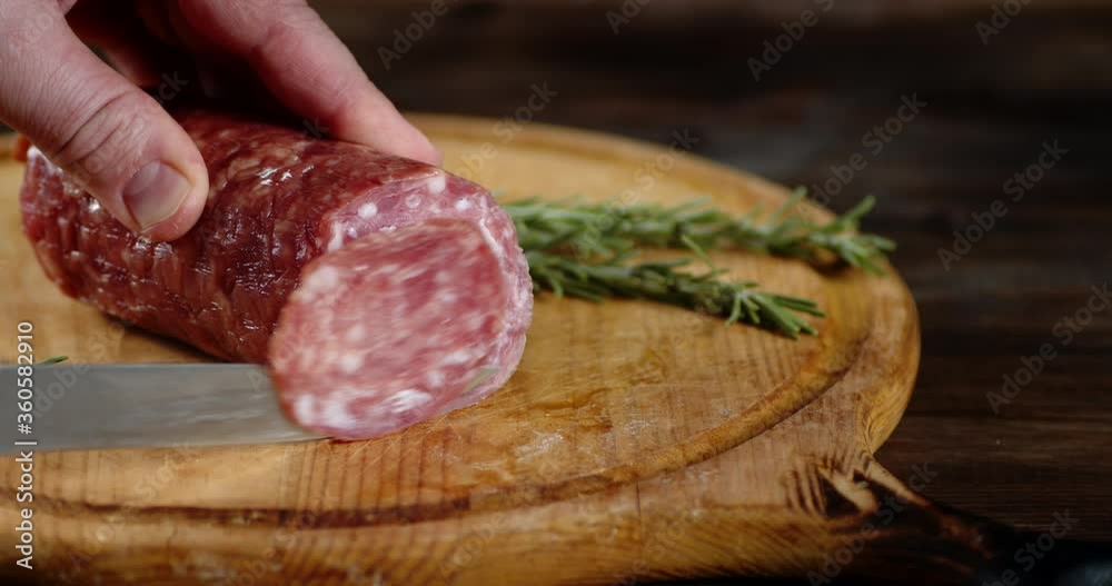 Salami cut into pieces with branches of rosemary. Salami cut into pieces with branches of rosemary.