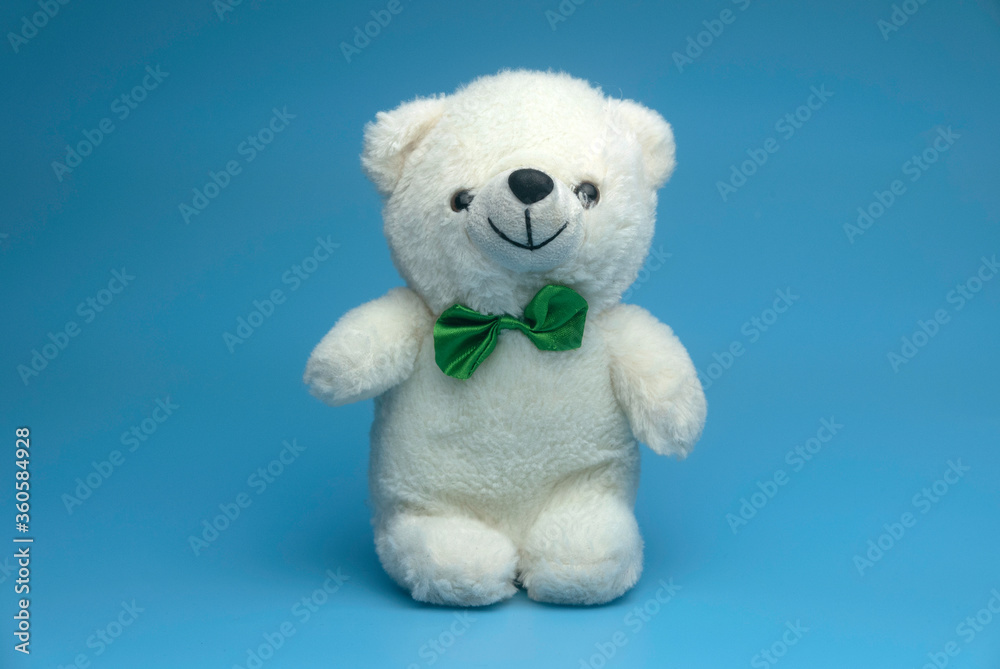 Selective focus of white teddy bear isolated on a blue background. Selective focus of white teddy bear isolated on a blue background.