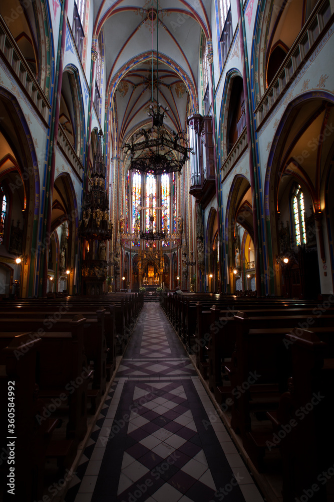 Scenic interior of the famous Catholic Church De Krijtberg Kerk. Long exposure shoot offers minute details of the vibrant decors, sanctuary, corridor and seats.
