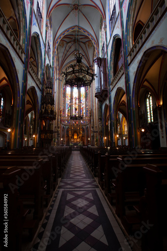 Scenic interior of the famous Catholic Church De Krijtberg Kerk. Long exposure shoot offers minute details of the vibrant decors, sanctuary, corridor and seats.