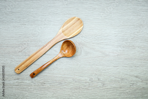 wooden spoons and spatula on a wooden background