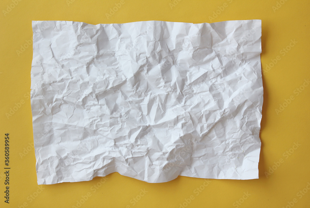 Crumpled paper isolated on yellow background . Crumpled paper isolated on yellow background .