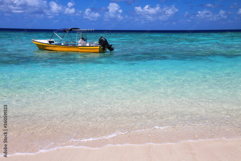 Tourist boat anchored at Gee island in Ouvea lagoon, Loyalty Islands, New Caledonia Tourist boat anchored at Gee island in Ouvea lagoon, Loyalty Islands, New Caledonia