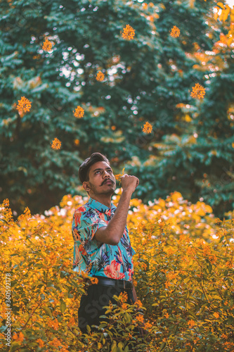 young man smelling flowers