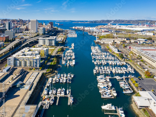 Foss Waterway and Tacoma Skyline. Along the waterway are condominiums and boat docks with a marina.