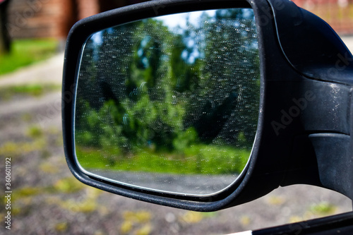 blurred reflection of green vegetation in a car mirror © Алексей Громов