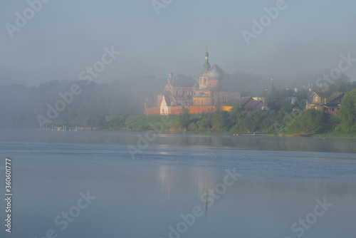 Foggy landscape with the Old Ladoga Nicholas Monastery in June early morning. Staraya Ladoga, Russia