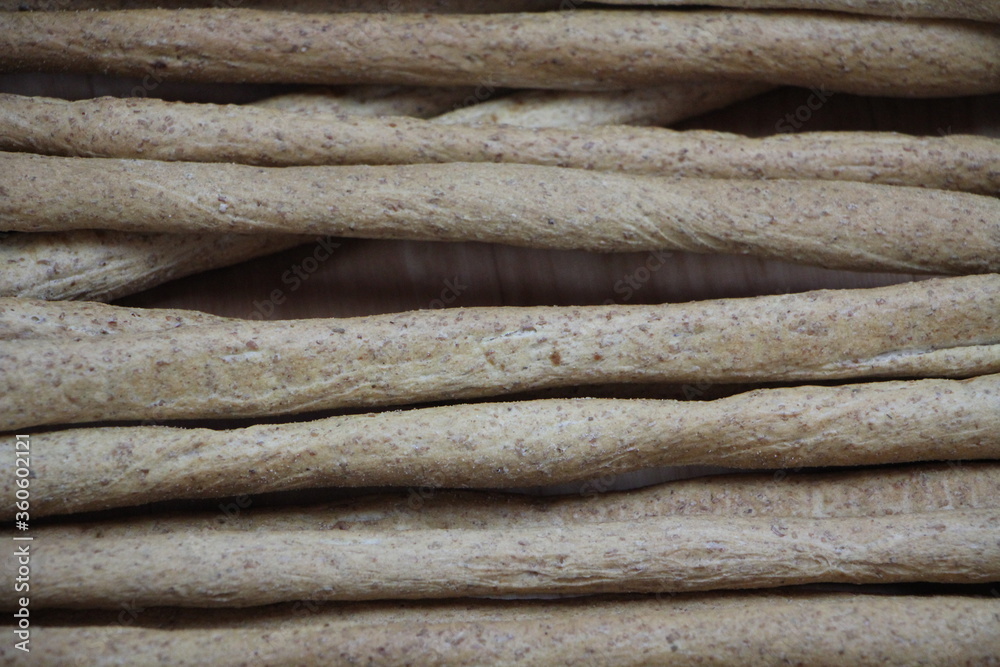 breadsticks, bread, rolls, pizza on wooden background