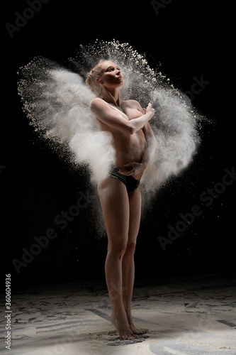 Fit topless female in cloud of dust
