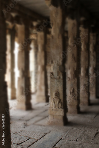 Blured images of old Hindu temple with carving on pillars
