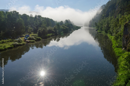 Morning mist on the water of Belaya river which reflects the sun. Bashkiria national park, Bashkortostan, Russia.