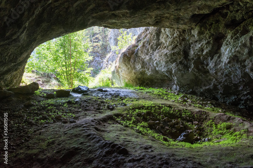 Entrance of Kulyurt-Tamak cave (Cosmonauts cave) and a karst sinkhole inside it. Bashkiria national park, Bashkortostan, Russia. © Kirill