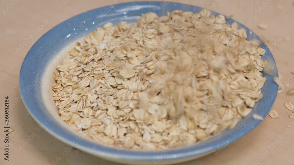 Rolled oats grains and plate mockup. Oats grains falling into plate. 4k video shot. Rolled oats grains and plate mockup. Oats grains falling into plate. 4k video shot.