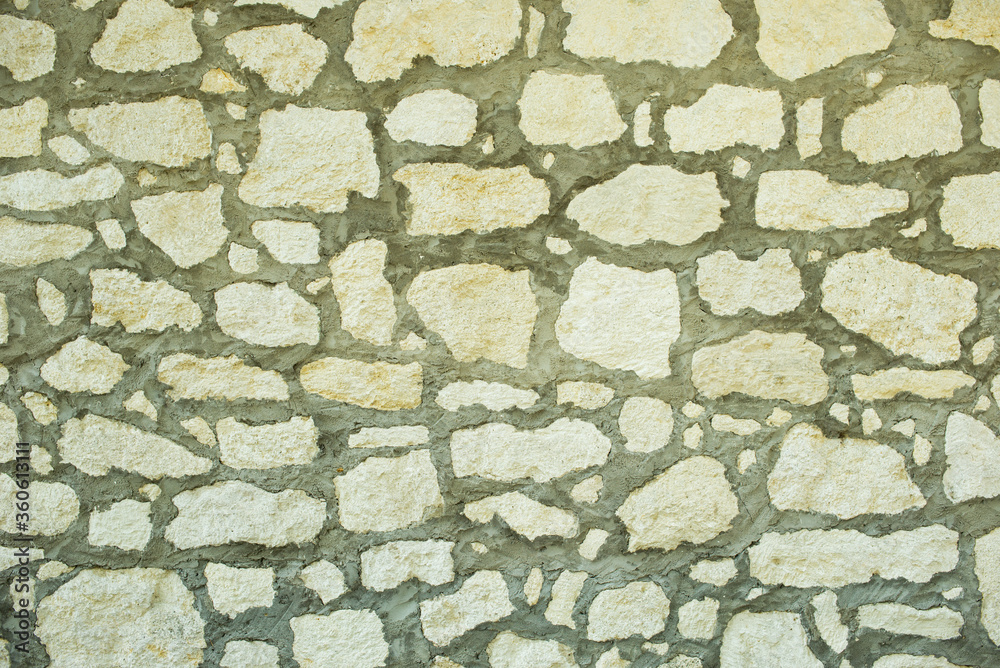 Wall made from a natural stone with cement joint. Stone wall texture for background Wall made from a natural stone with cement joint. Stone wall texture for background