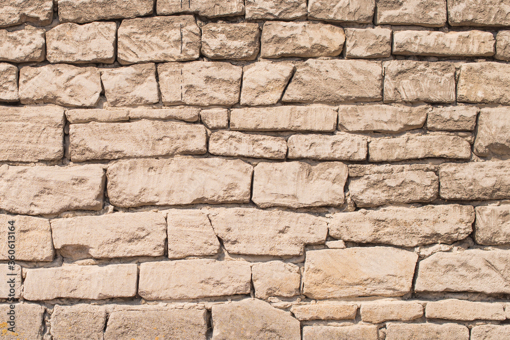Old different size stone wall. Wall made from a natural stone. Stone wall texture as a solid background Old different size stone wall. Wall made from a natural stone. Stone wall texture as a solid background