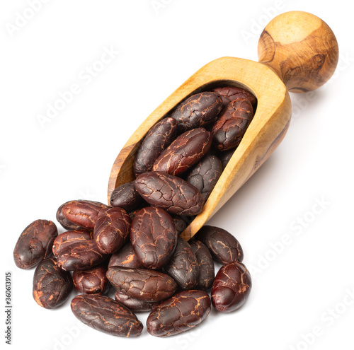 peeled cocoa beans in the wooden scoop, isolated on white background