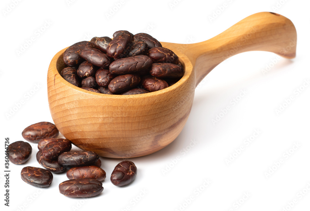 Fototapeta premium peeled cocoa beans in the wooden spoon, isolated on white background