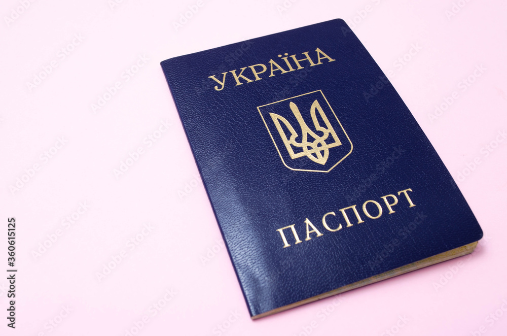 Ukrainian passport on a pink background. The passport of the citizen of Ukraine in the macro. Passport General plan and close-up Ukrainian passport on a pink background. The passport of the citizen of Ukraine in the macro. Passport General plan and close-up