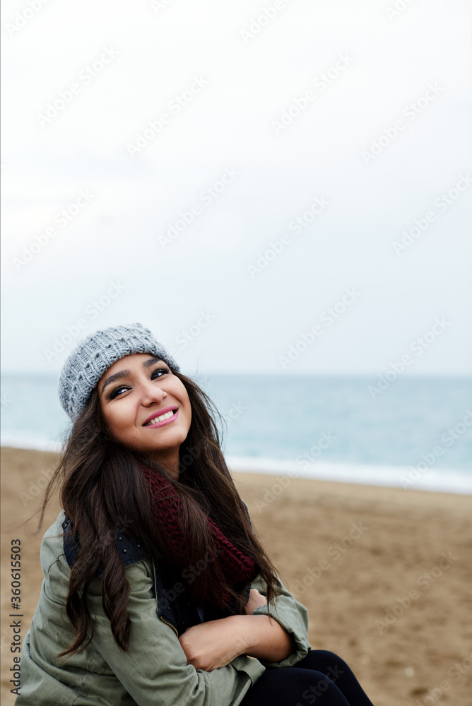 Portrait of smiling woman at leisure time outdoors with copy space area, cold autumn day, attractive happy girl on promenade on the beach with beautiful sea on background Portrait of smiling woman at leisure time outdoors with copy space area, cold autumn day, attractive happy girl on promenade on the beach with beautiful sea on background