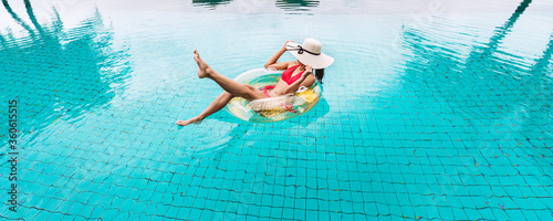 Traveler asian woman relax with pool float in resort summer Thailand