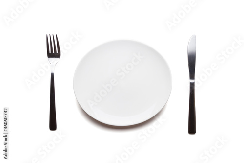 White plate with fork and knife on white background