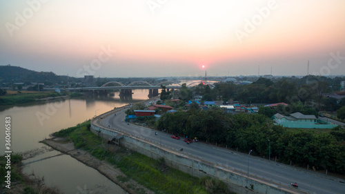 .scenery sunset above Dechatiwong bridge across Chao Phraya river in Nakornsawan province Thailand