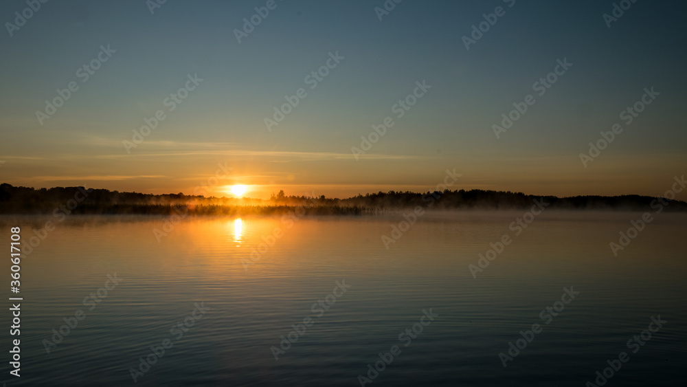 Foggy weather early in the morning on the lake. beautiful wallpapers. a mystical mist vibrates in the lake. summer sunrise Foggy weather early in the morning on the lake. beautiful wallpapers. a mystical mist vibrates in the lake. summer sunrise