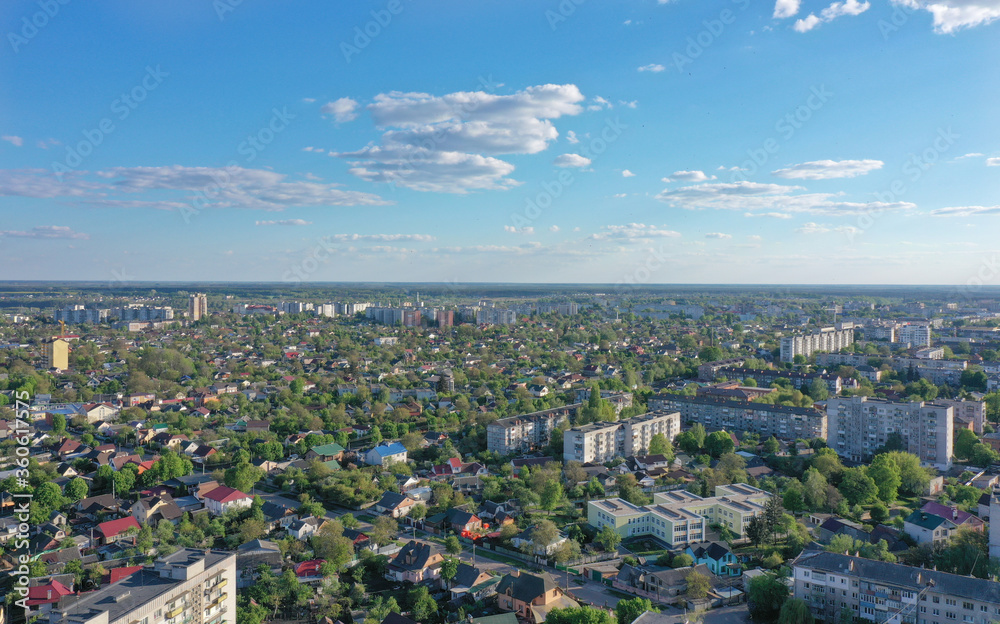Fototapeta premium urban landscape against the blue sky and many trees