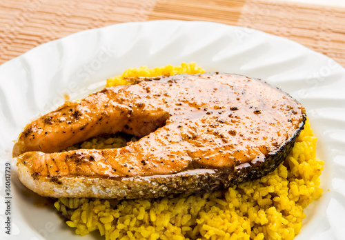 Salmon steak with yellow rice in plate, in door  Chiangmai  Thailand