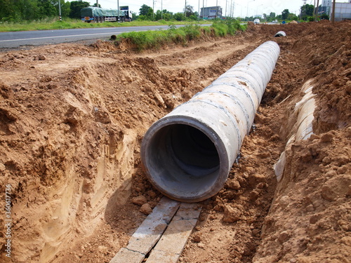 Wallpaper Mural Slabs supporting drains in the ground. On the ground background in the construction of a water side drainage system. Selective focus Torontodigital.ca