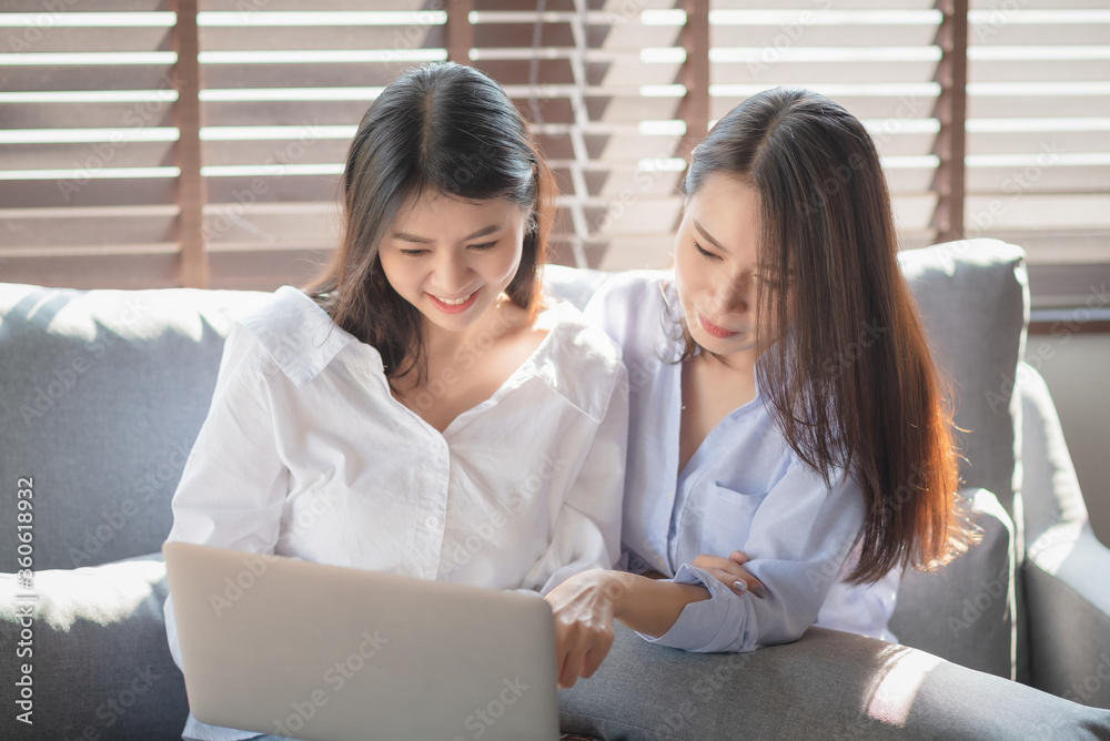 Two young woman use laptop computer to shopping online via internet during stay safe at home Two young woman use laptop computer to shopping online via internet during stay safe at home