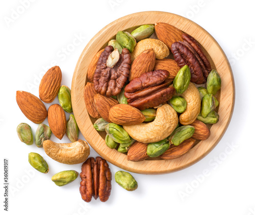 unsalted mixed nuts in the wooden plate, isolated on white background, top view