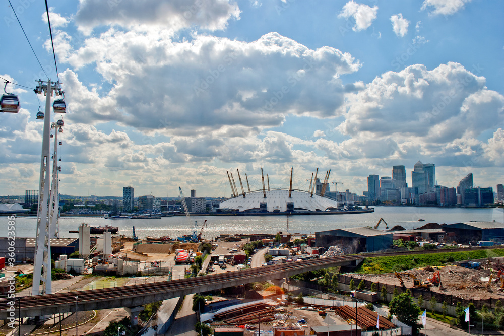 Emirates Air Line cable car travels over the Thames and The O2 Arena Greenwich London Docklands
