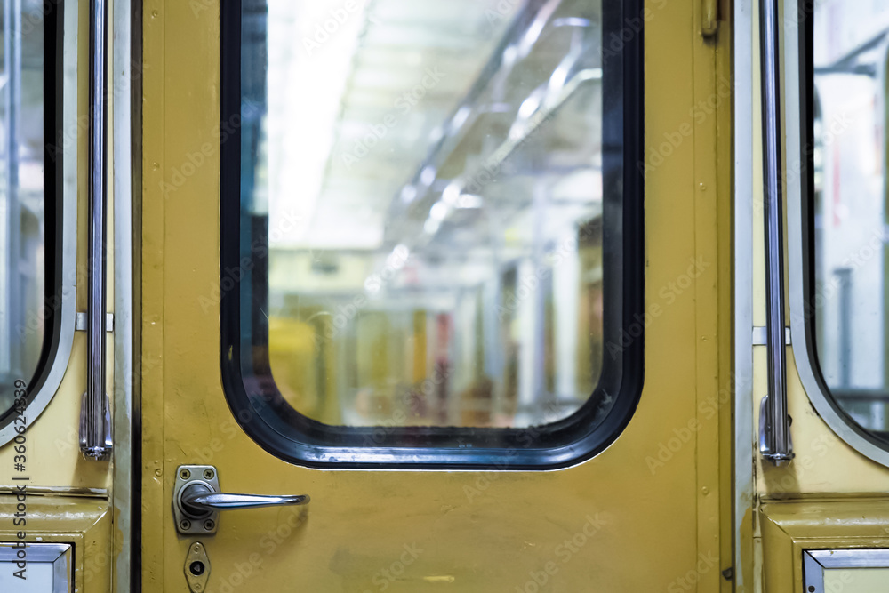 Old metro car, door of the transition between the subway cars, underground public transport