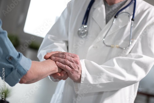 Doctor holding patient hand © thodonal