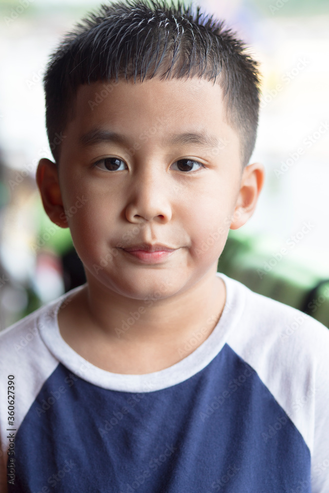 headshot of asian boy looking with eye contact to camera